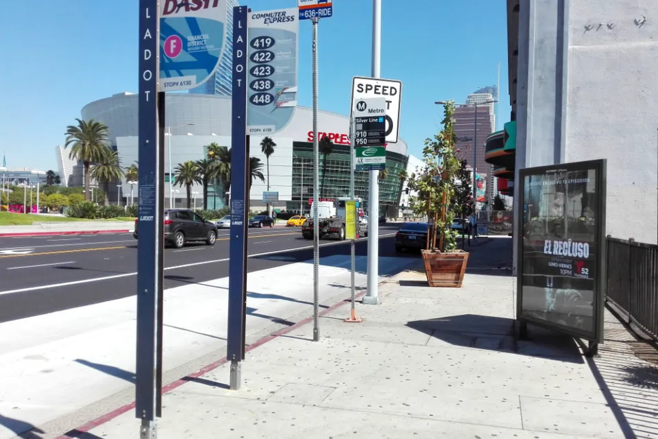 Bus stop in downtown Los Angeles with billboard and no bench or shelter